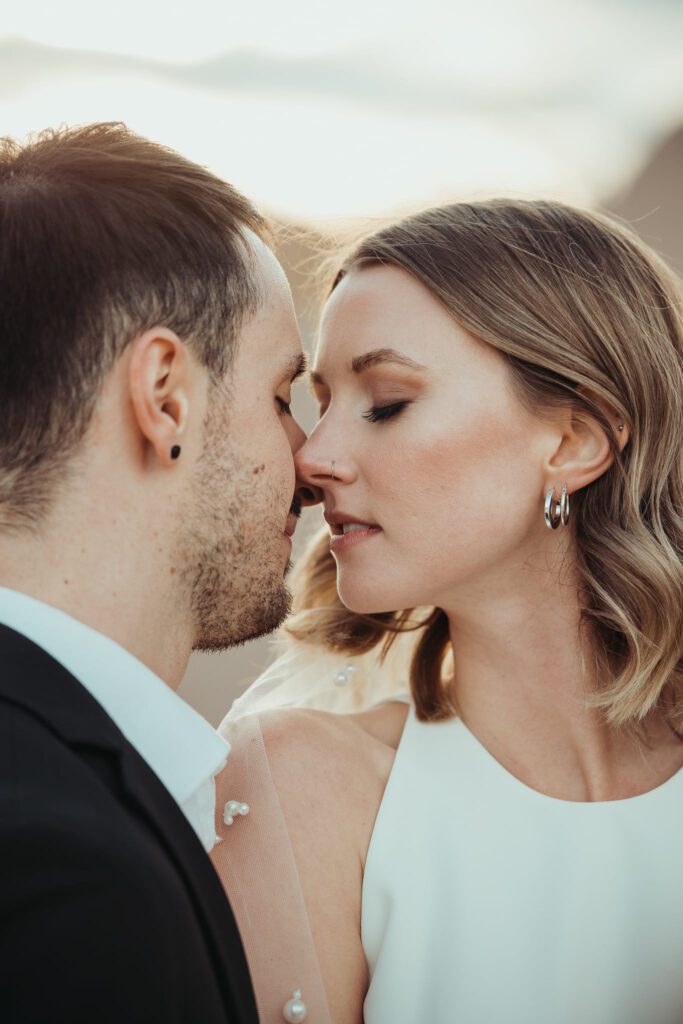 Couple in Joshua Tree, California kissing for wedding portraits