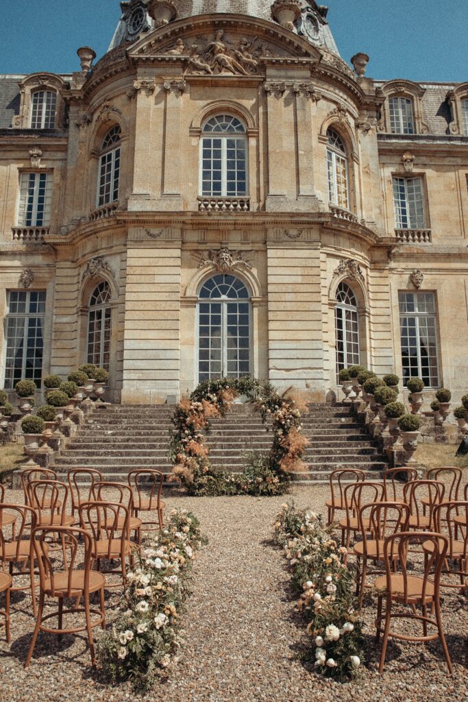 A ceremony space set up outside of the wedding venue Chateau de Champlatreux in France. 