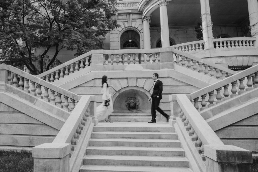 Bride and Groom on the steps of Elkin's Estate walking towards each other. 